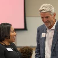 Briette Phillips talking with Mike Jandernoa